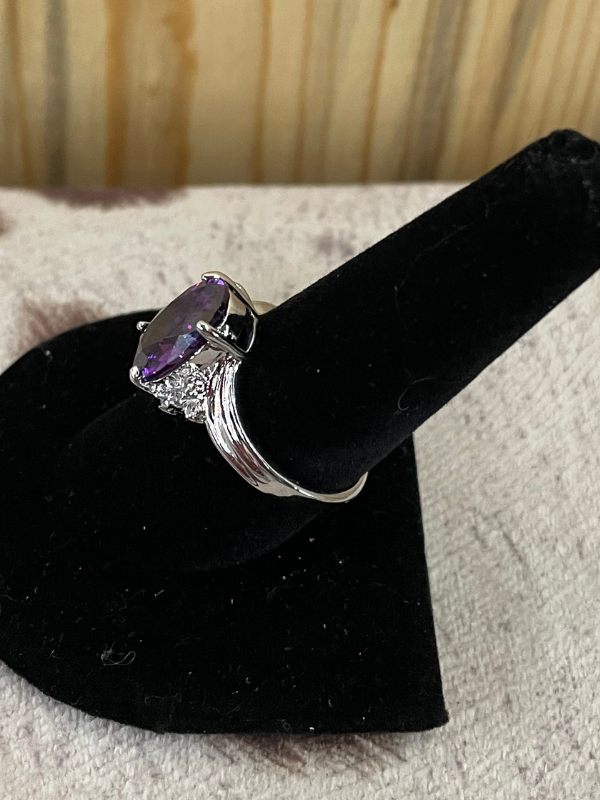 Large Purple Oval Stone with Clear Stones on the Side Ring